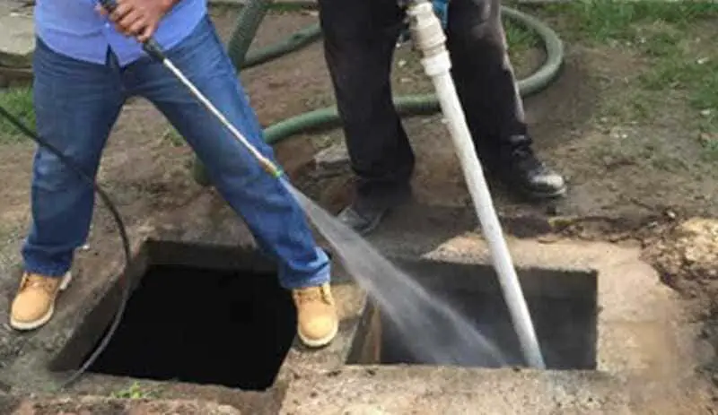 Steps to fix a septic tank that backs up when it rains.